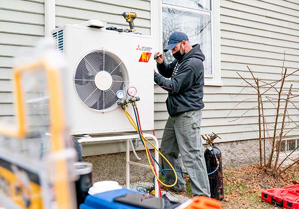 Man working on heat pump