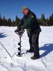 FW Tech Paul Campbell drilling holes for post