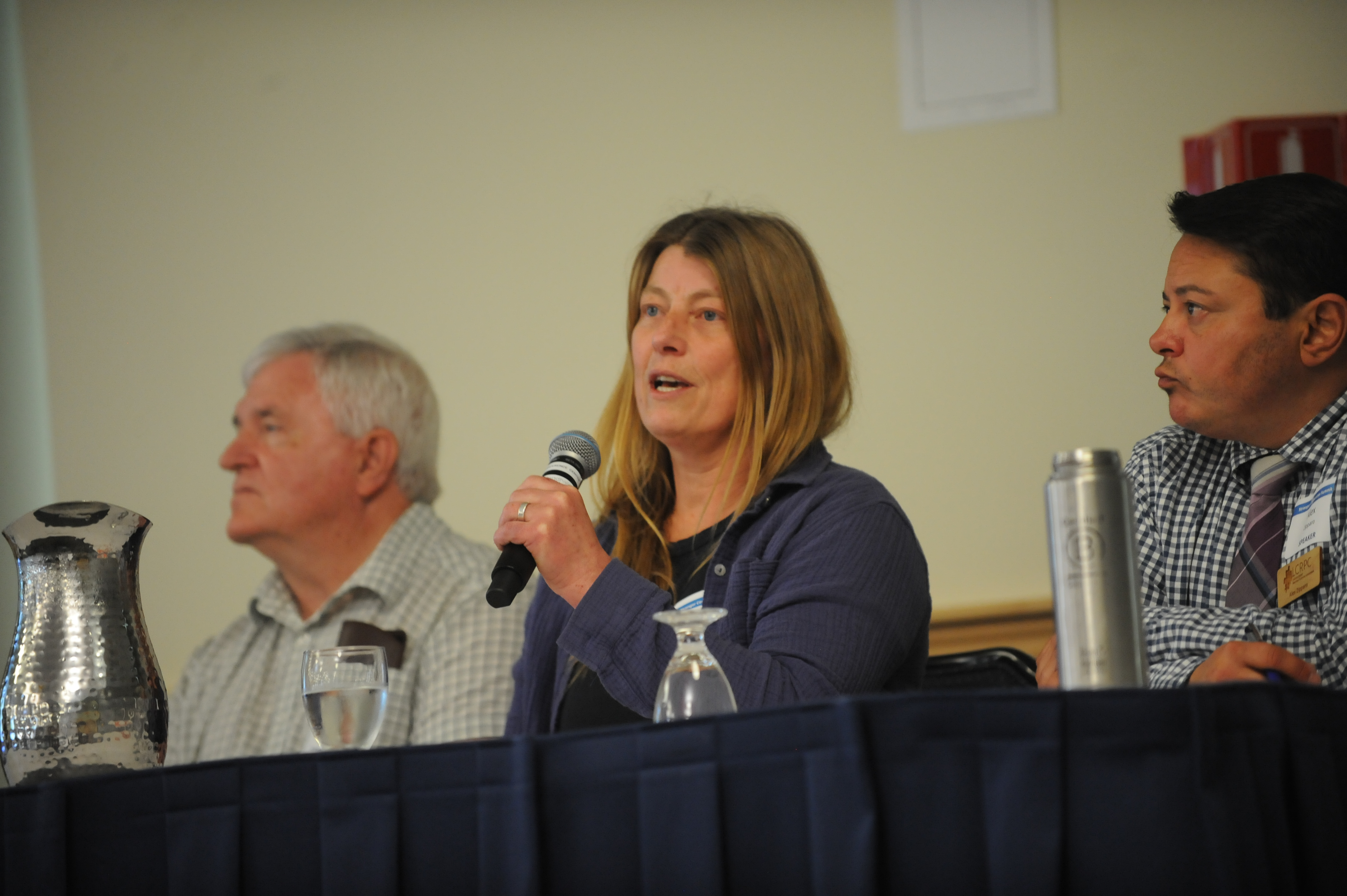 A woman speaking into a microphone. 